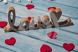 Wooden word love with heart romance with white coffee cup of hot chocolate and small marshmallows. Minimal