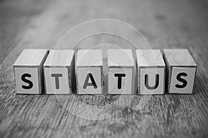 Wooden word on wooden table background concept  - Status