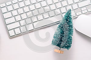 Wooden working table with computer keyboard, mouse and christmas