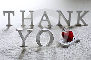 Wooden wthite letter Thank you on the crumpled carpet photo