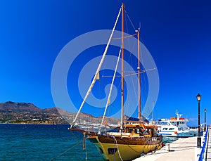 Wooden yacht in form of an old pirate ship in port of Agios Nikolas, Crete, Greece
