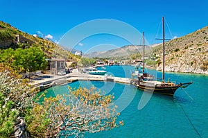 Wooden yacht standing in cosy port on Greek island