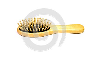 Wooden yellow hair massage comb on a white background