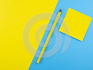 Wooden yellow pencil isolated on blue texture paper and combine with yellow square. Minimalist template with copy space