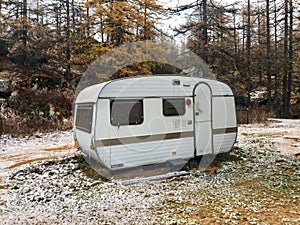 Uninhabited camper in the snowy wood. Piedmont, Val di Susa, Italy photo