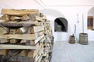 Woodpile against the background of a Russian bleached stove