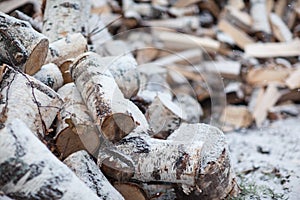 Woodpile with birch firewood. Snow Covered Firewood