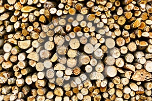 Woodpile of firewood. Wood texture. Firewood stacked in one background