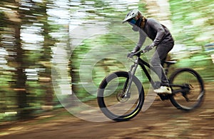 Woods, bicycle and man travel, blur and workout outdoor in forest for healthy body. Mountain bike, nature and athlete