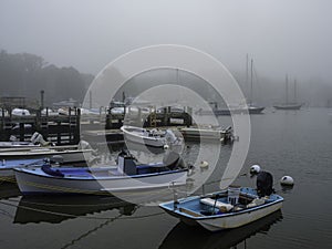 Woods Hole Marina Seascape in a Foggy Summer Morning. Moored Boats and Yachts.