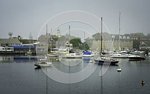 Woods Hole Marina Seascape in a Foggy Summer Morning. Moored Boats and Yachts.