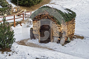 Woodshed hut with wood logs