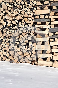 Woodshed with pieces of wood piled for winter