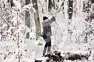 Woodsman with trees covered by snow on background