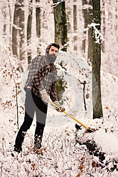 Woodsman with trees covered by snow on background.