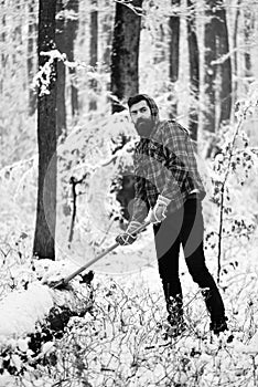 Woodsman with trees covered by snow on background.