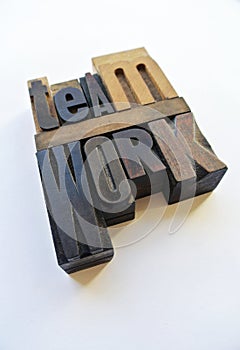 Woodtype letters showing teamwork