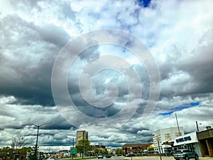 Woodward Avenue in Downtown Birmingham, Michigan on a cloudy Day. The boulavard and residential towers of Downtown Birmingham can