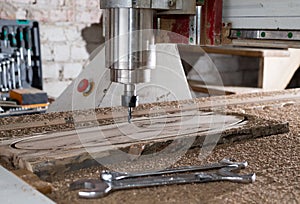 Woodwork cnc machine working on wood board. Tool at the wood factory