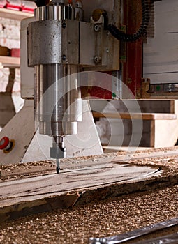 Woodwork cnc machine working on wood board. Tool at the wood factory