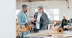 Woodwork, teamwork and carpenter with tablet in a workshop manufacturing a bird house. Engineering planning, people or