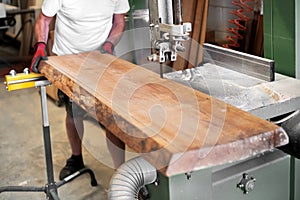 Woodworker cutting a large panel with a band saw