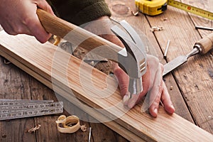 Woodworker hammer a nail