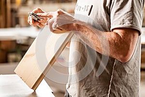 Woodworker measuring with his caliper