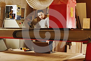 Woodworker operates the machine with program numerical control. Cnc router.