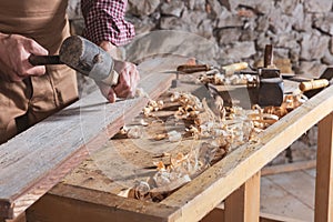 Woodworker using chisel to smooth down wood photo