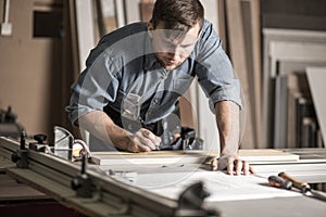 Woodworker working on professional workbench photo