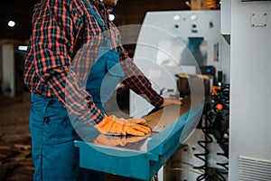 Woodworker works on machine, lumber industry