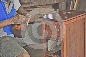 Woodworkers are repairing the drawers, photo