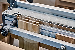 Woodworking and carpentry production. Part of a wooden box, made with a milling machine. Dovetail coupling. Close-up photo
