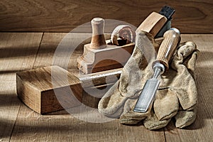 Woodworking tools wooden mallet chisel gloves and woodworkers plane