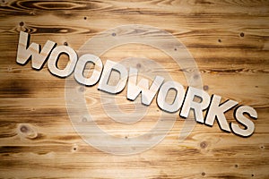 Woodworks word made of wooden block letters on wooden board