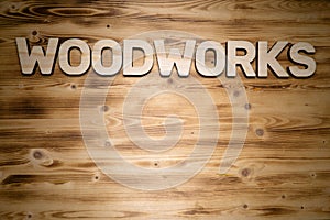 WOODWORKS word made of wooden letters on wooden board