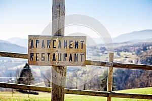 A woody borad which indicated parking restaurant in Catalan language