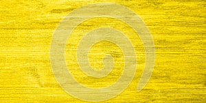 Woody yellow textured background in the trendy Mellow Yellow color. copy space, color trend, board surface