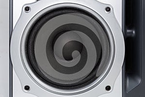 Woofer of the home loudspeaker in silvery housing close-up