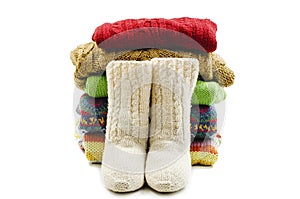 Wool socks and stack of various sweaters. Winter style