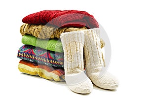 Wool socks and stack of various sweaters. Winter style