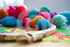 Woolen balls of yarn, tambour and embroidery.