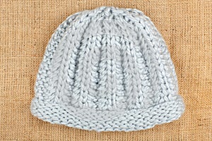Woolen cap isolated on linen background.