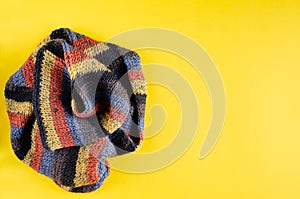 Woolen scarf composition on yellow background. Flat lay