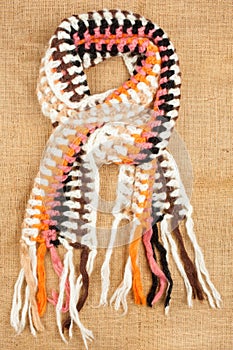 Woolen scarf isolated on linen background.