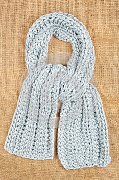 Woolen scarf isolated on linen background.