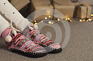 Woolen socks on the background of gifts. Christmas tree. New Year