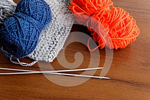 Woolen thread, knitting, knitting needles on wooden table