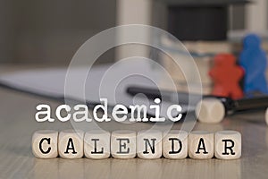 Word ACADEMIC CALENDAR composed of wooden dices